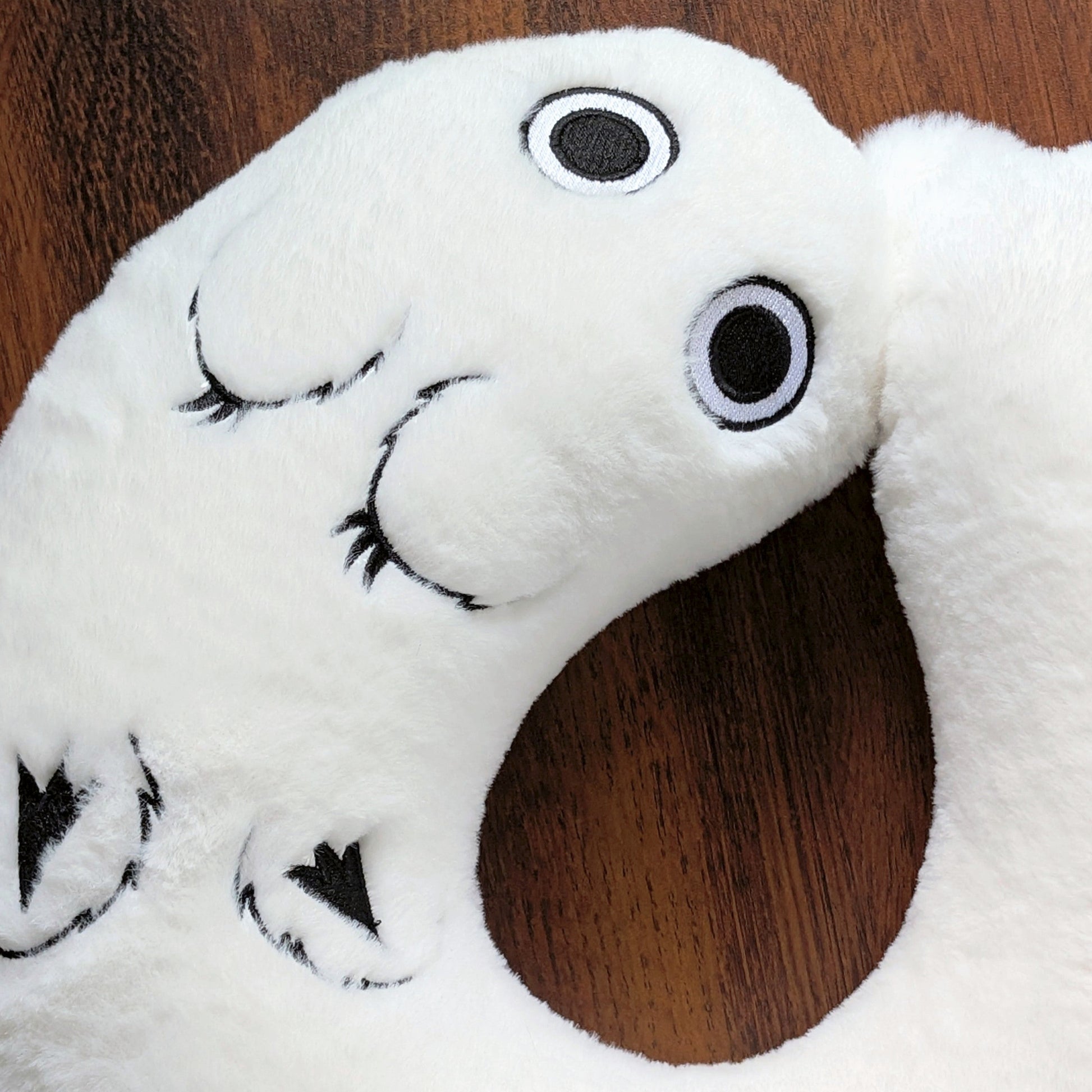 Detail of Brushbuddy neck pillow showing the entire embroidered body.