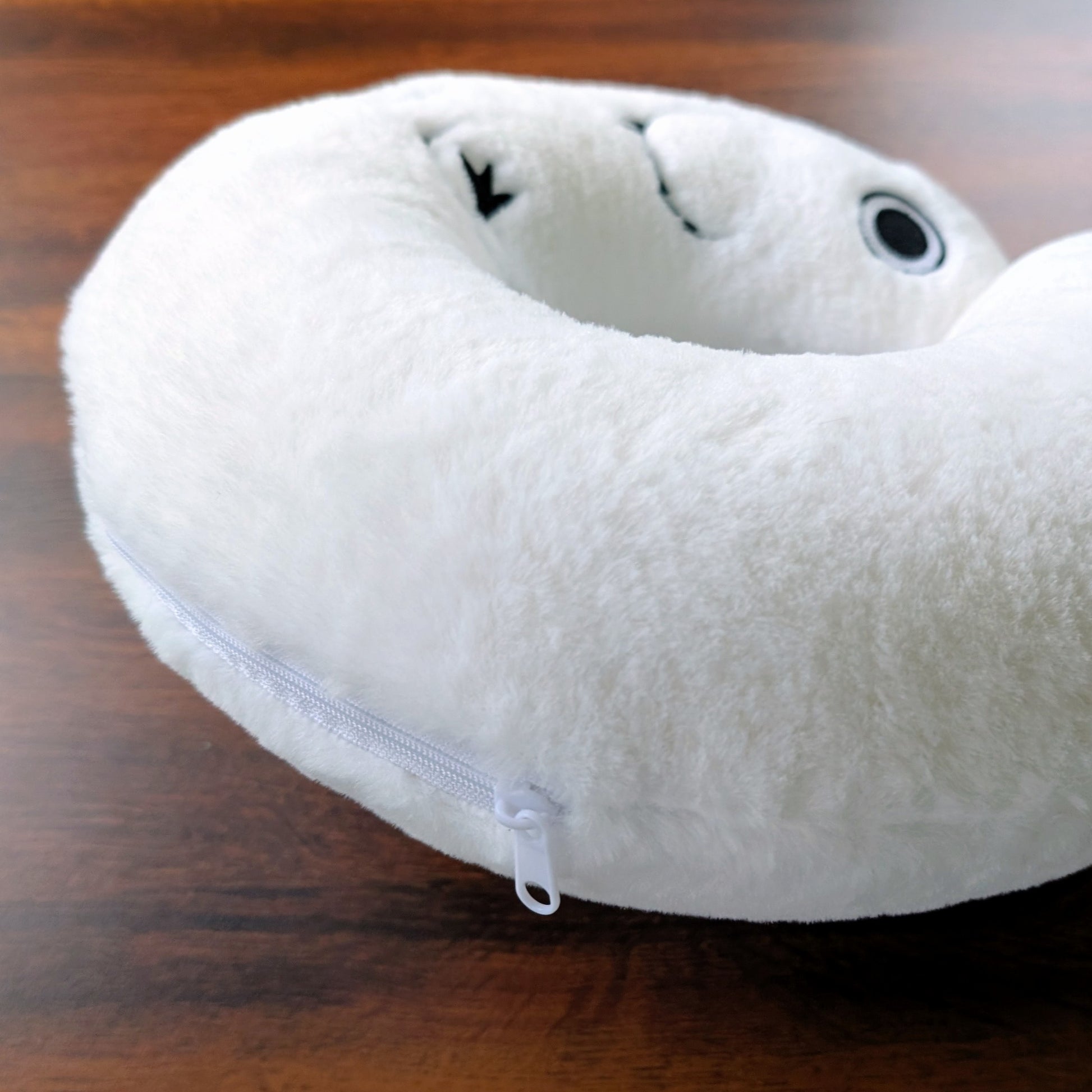 Detailed close-up of Brushbuddy neck pillow's zipper for replacing fill